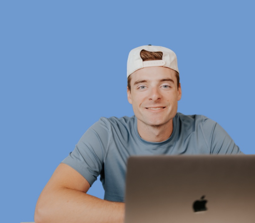 Isaac Beachy smiling behind his laptop